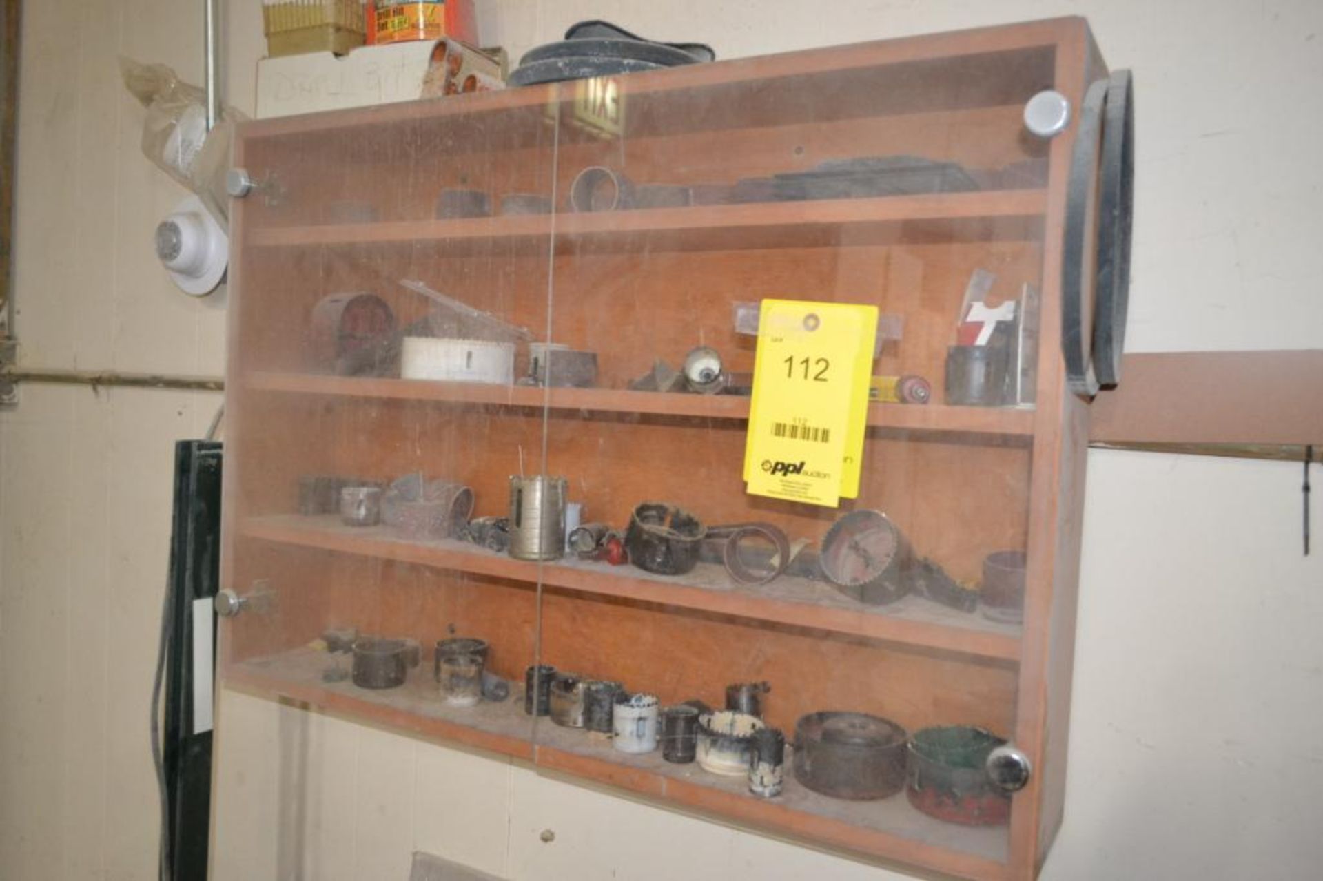 LOT: Cabinet with Hole Saw Blades (on wall)