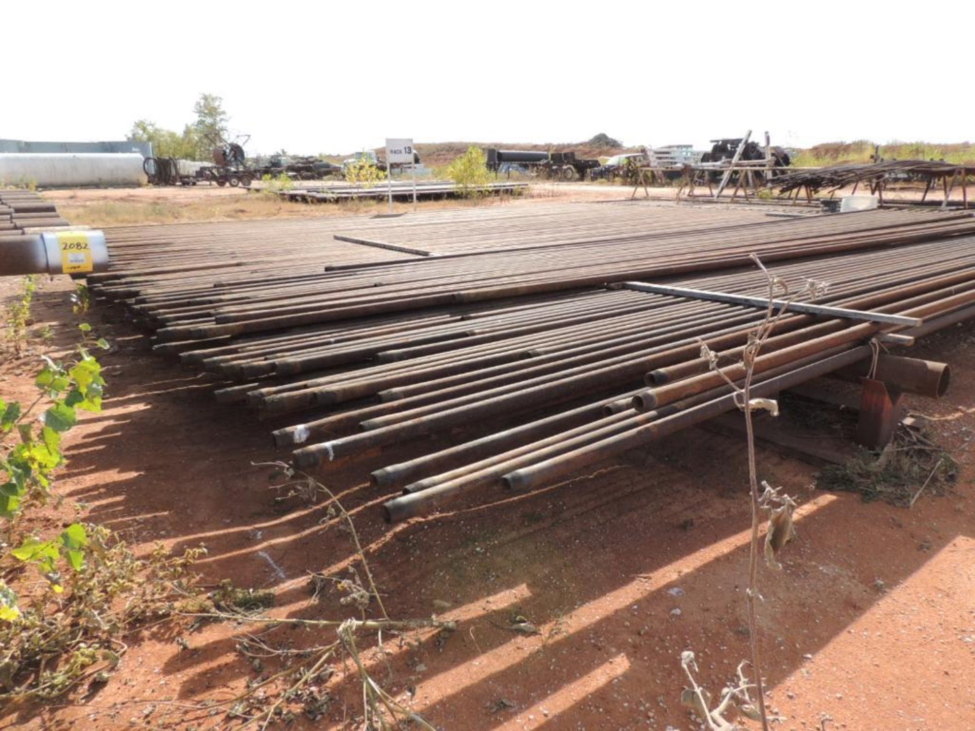 LOT: 2 3/8 In. J55 Tubing 7,800 Ft. Estimated, Pipe Racks included (Located Lower Yard)(LOCATED IN H - Image 7 of 8