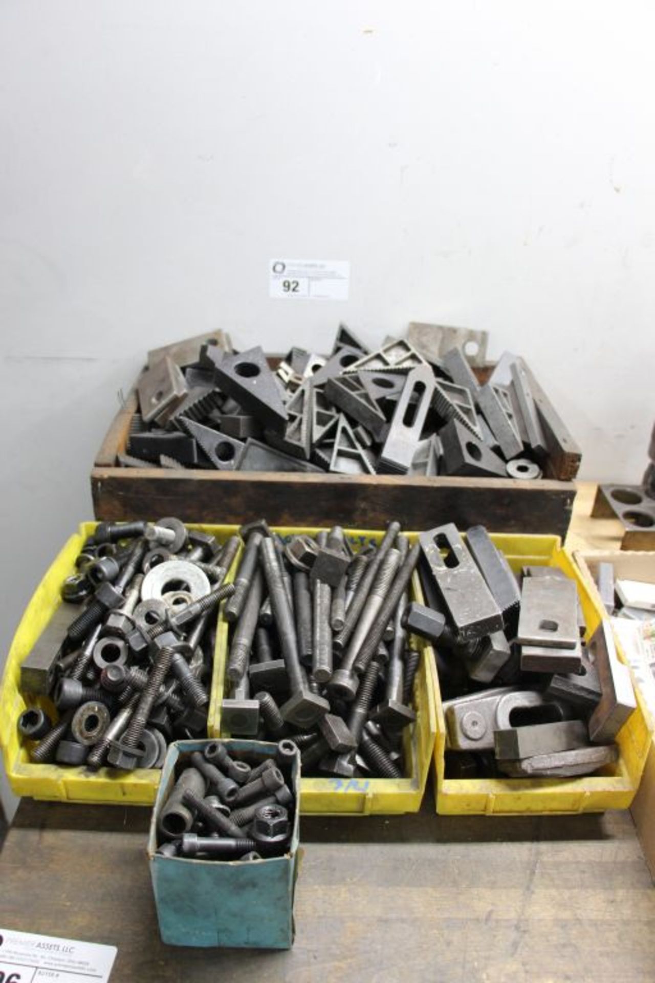 Large assortment of mold clamps, jaws, and bolts