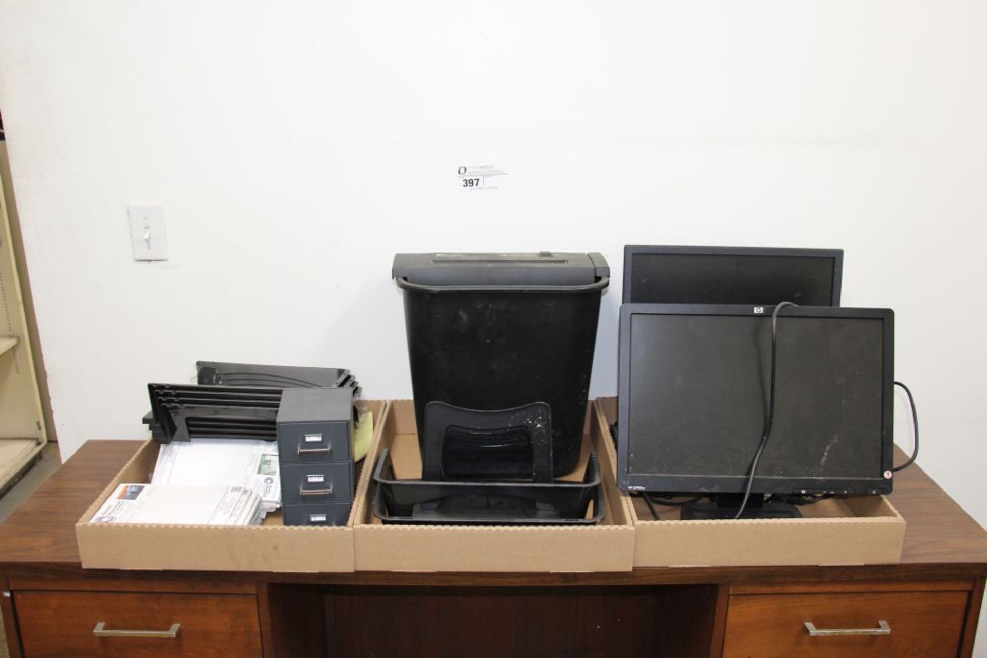 assortment of office supplies, monitor, power shreader