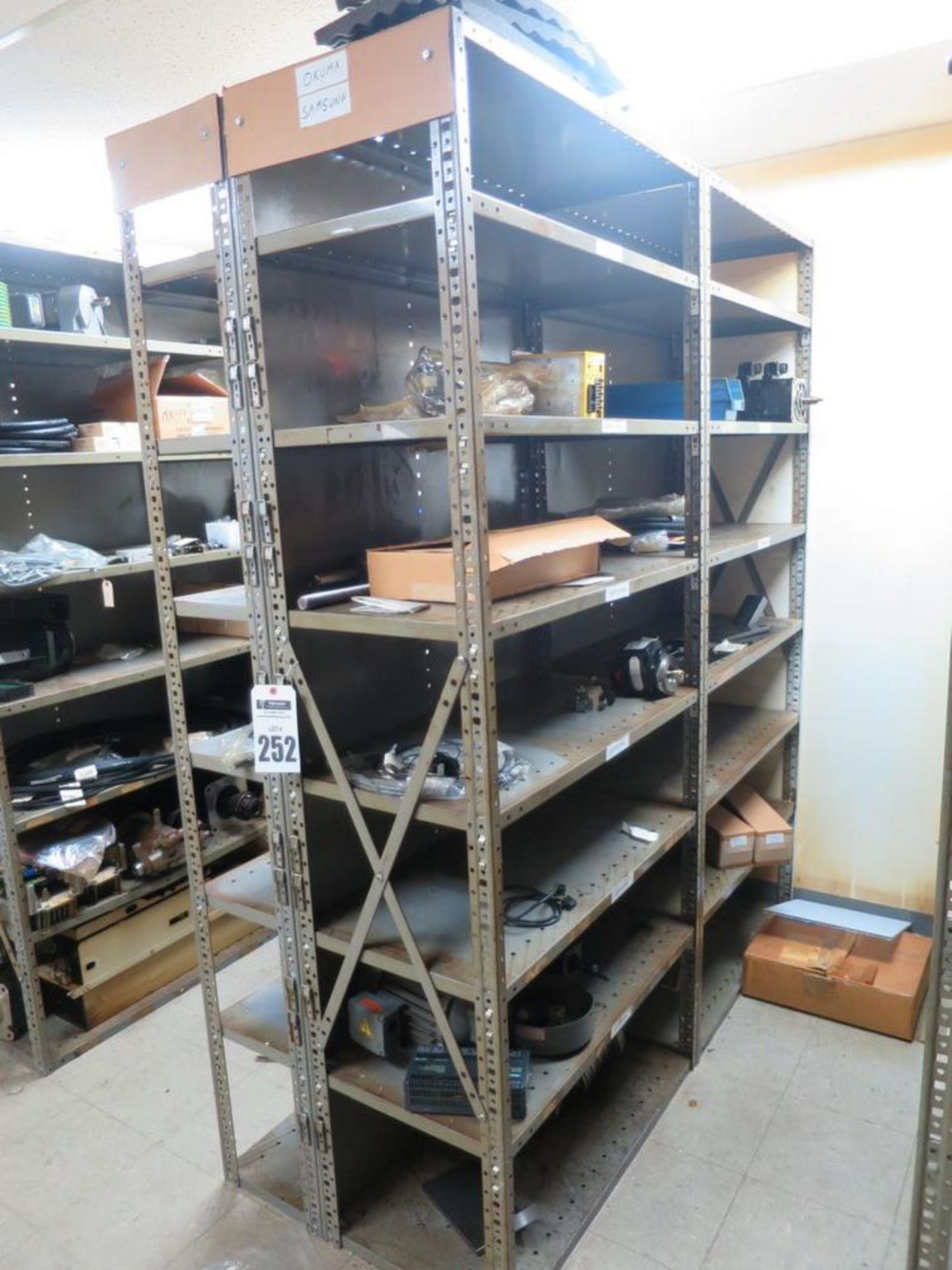 (4) Shelving Units with Okuma and Samsung Spare Parts