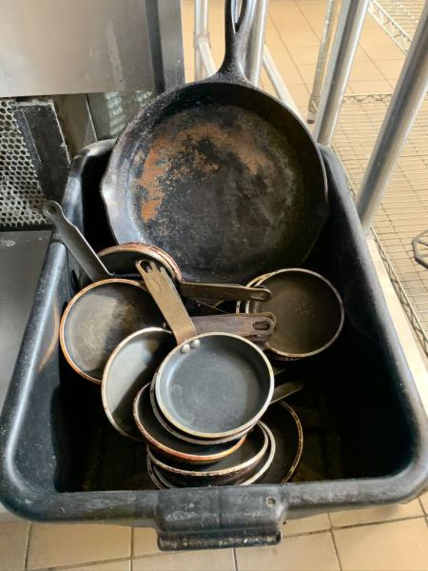 Black Bus trays with misc fry pans plus 2 cast iron frying pans