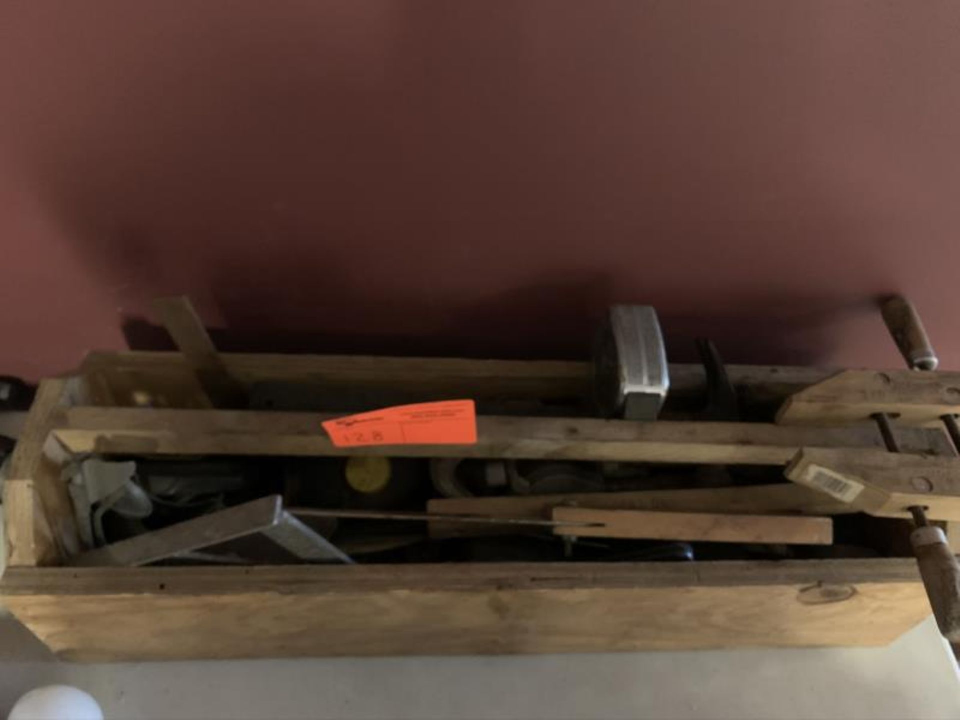 Lot of wooden tool box with tools including clamps, measureing tape, angles