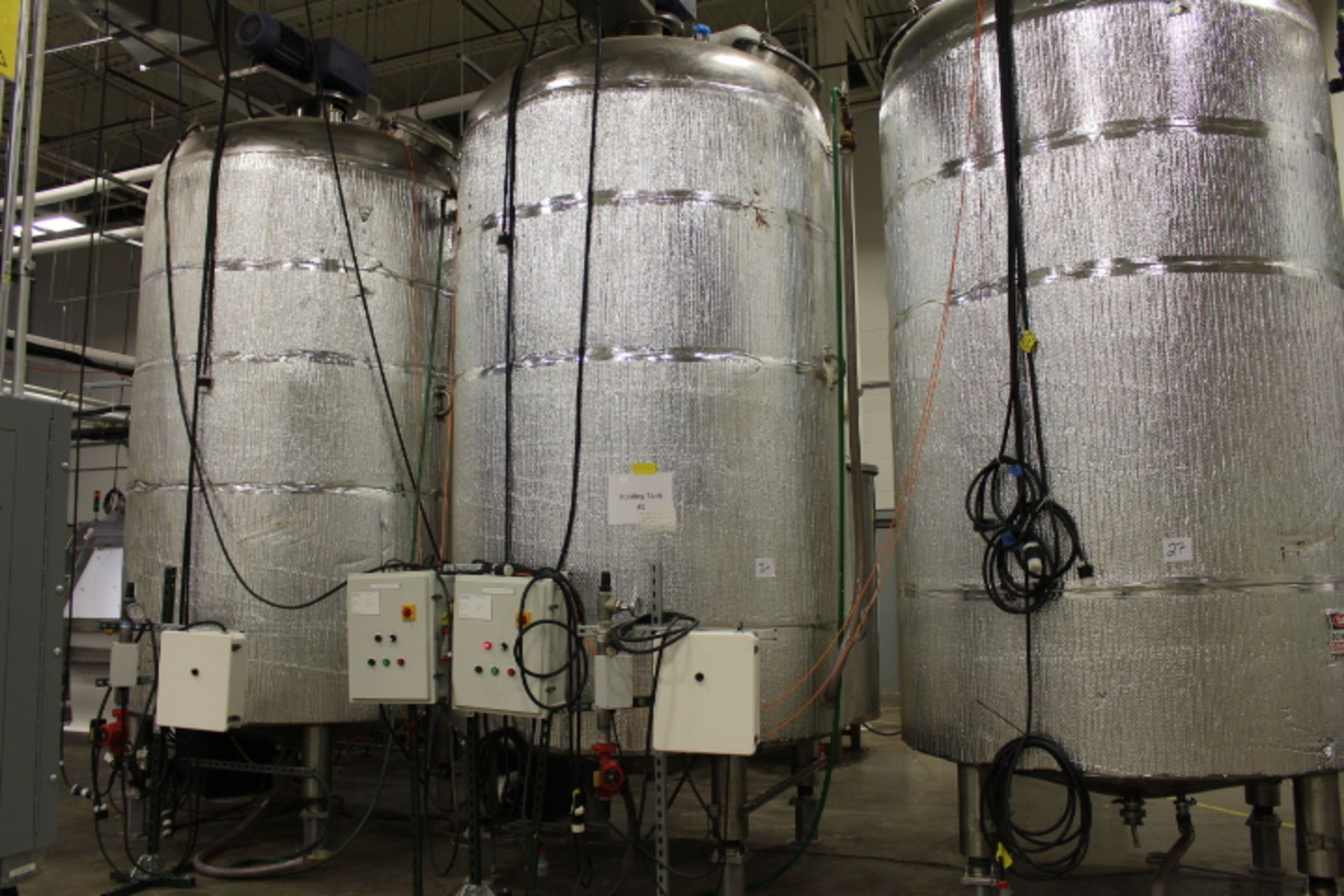 28,000 lb (approx) stainless steel vertical, water jacketed agitated liquid Chocolate Holding Tank