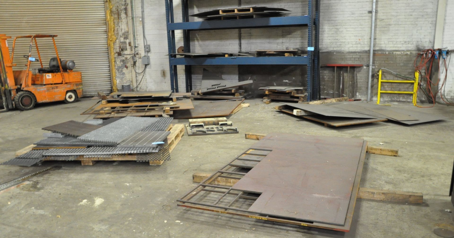 Lot-Expanded Metal Grates and Steel Plate Stock in (9) Stacks on the the Floor and in (1) Rack