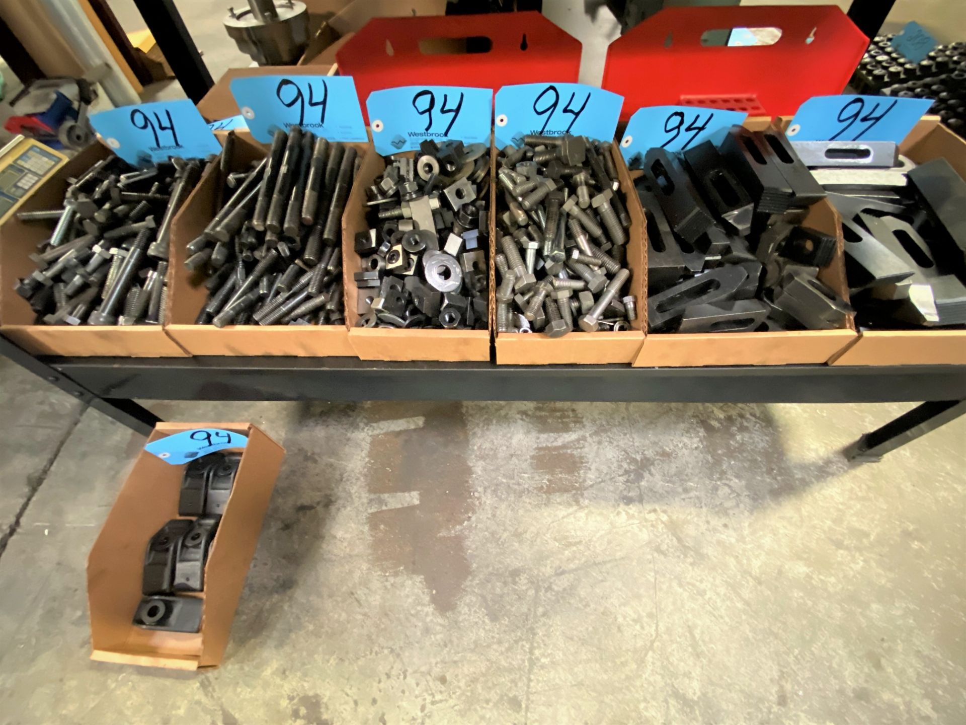 Lot-Hold Down Tooling in (8) Boxes with (2) Hold Down Stands Under (1) Bench