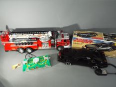 A large, unboxed battery operated American fire engine by New Bright,