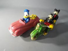 Two cast iron figures depicting Donald Duck and Mickey Mouse [QD&MKM] This lot must be paid for and