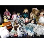 A quantity of porcelain and ceramic dolls (in excess of 25) in various condition,