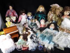 A quantity of porcelain and ceramic dolls (in excess of 25) in various condition,