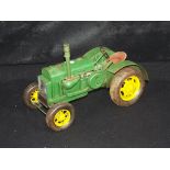 A tin plate model of a Farm Tractor, measuring approximately 30cms in length. The model is unboxed.