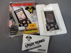 Hand Held Electronic Games - a Grandstand Leisure Products Crazy Kong LCD Pocket Arcade game,