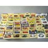 Lledo - a collection of 57 diecast model vans and cars in various scales,
