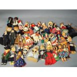Vintage dolls - a box containing a quantity of vintage dolls to include International costume dolls