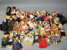 Vintage dolls - a box containing a quantity of vintage dolls to include International costume dolls