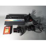 Atari - An unboxed Atari 2600 games console with two control pads,