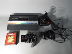 Atari - An unboxed Atari 2600 games console with two control pads,