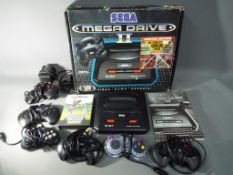 Sega - A boxed Sega Mega Drive II games console with six controllers,