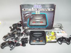 Sega - A boxed Sega Mega II console with five controllers,