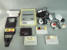Nintendo - A Nintendo SNES game console with three controllers,