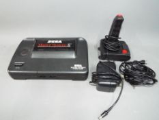 Sega - An unboxed Sega Master System II games console with power cable and joystick.