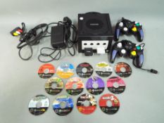 Nintendo - A Nintendo GameCube console with two controllers,