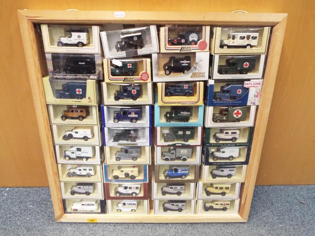 A display case containing 36 boxed diecast model emergency vehicles by Lledo, models appear mint.