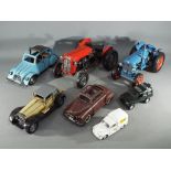 Five tin plate ornamental model vehicles and 2 diecast model cars.