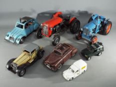Five tin plate ornamental model vehicles and 2 diecast model cars.