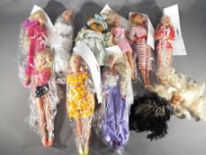 Barbie - 8 dressed Barbie dolls contained in home made packaging, a Barbie head and jacket,