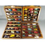 Four display cases each containing fifteen diecast vehicles.