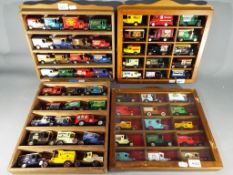 Four display cases each containing fifteen diecast vehicles.