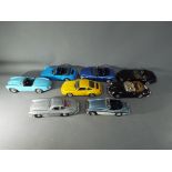 Eight unboxed 1:18 scale diecast model motor vehicles by Bburago / Burago, Maisto and ERTL.