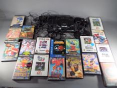 Sega - An unboxed Sega Mega Drive games console with two controllers and eighteen games cartridges