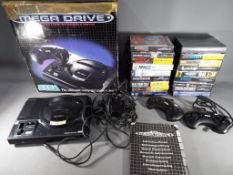 Sega - A boxed Sega Mega Drive games console with two controllers,