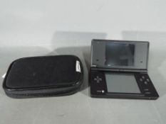 Nintendo - A black Nintendo DSi in carry case with Professor Layton and the Unwound Future game