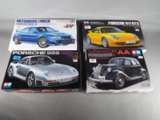 Tamiya Japan - four Tamiya Japan 1/24 Sports Car Series model cars to include Mitsubishi Lancer