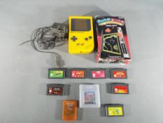 Nintendo - A Nintendo Game Boy hand held games console in yellow with eight Game Boy and Game Boy