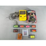 Nintendo - A Nintendo Game Boy hand held games console in yellow with eight Game Boy and Game Boy