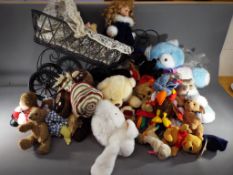 A collection of over 20 soft toys including TY Beanies and similar with a dolls pram and doll.