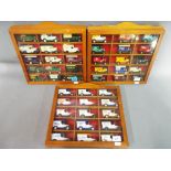 Three display cases each containing fifteen diecast vehicles.
