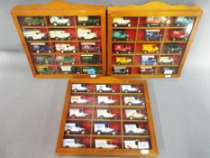 Three display cases each containing fifteen diecast vehicles.