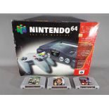 Nintendo - A boxed Nintendo N64 games console with controller and three game cartridges comprising