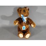 Steiff - a Steiff bear with gold colored button in ear, white label, original Steif tag,