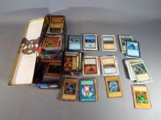 A tin containing a quantity of trading cards to include Magic the Gathering, Yu-Gi-Oh!, X-Men,