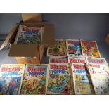 A box containing a quantity of vintage comics including Beezer, Topper, Whizzer and Chips.
