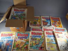 A box containing a quantity of vintage comics including Beezer, Topper, Whizzer and Chips.