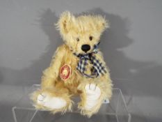 Charlie Bear - a Charlie Bear entitled Olly HCB079998 with ribbon,