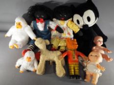 A mixed lot to include two black dolls, Felix the cat, two soft toys by Gilroy,