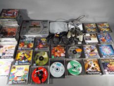 Playstation - Two Sony Playstation games consoles, two controllers and approximately 36 boxed games.